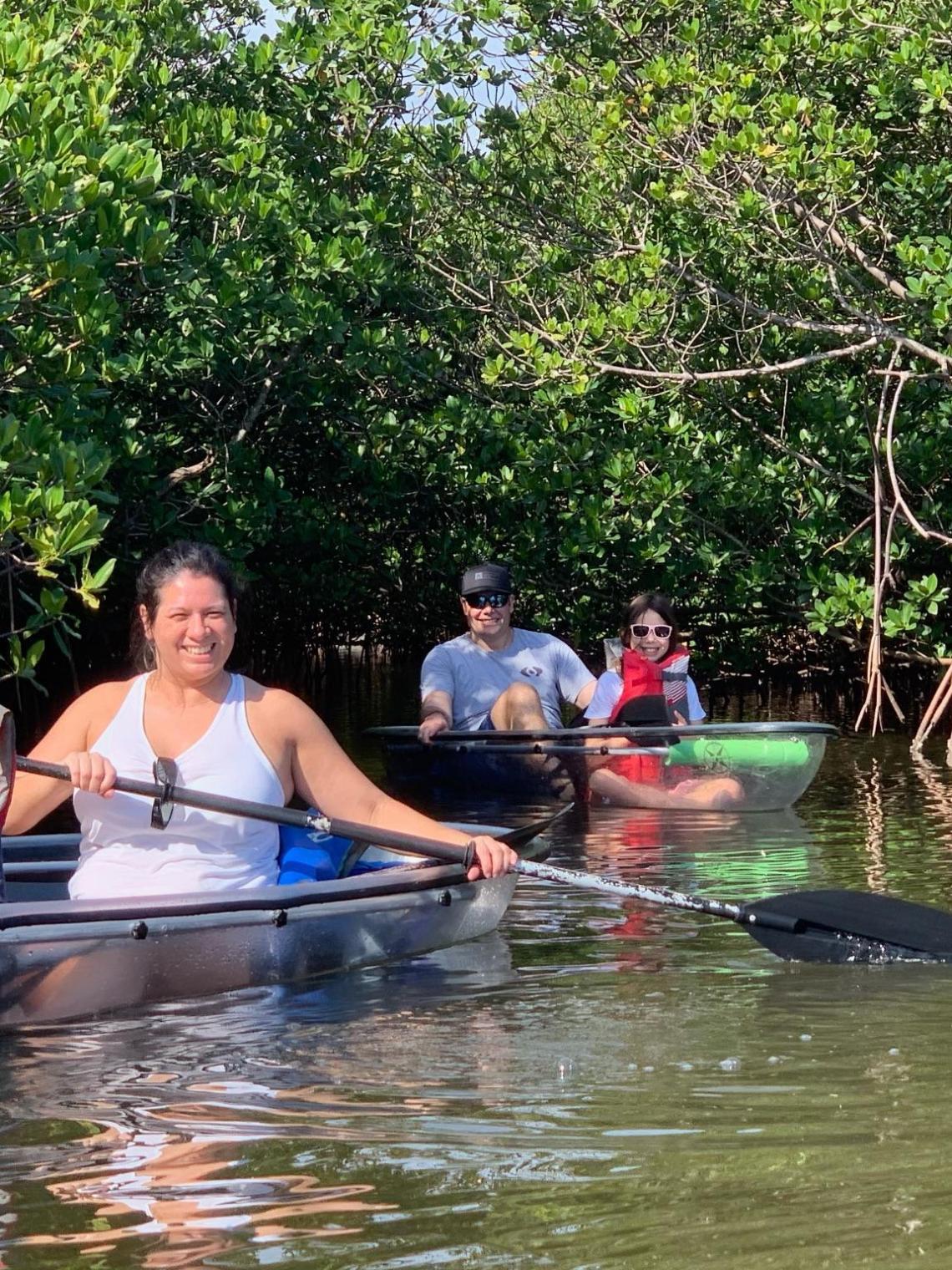 a group of people rowing a boat in the water