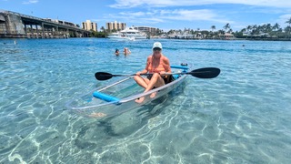 a young girl riding a wave on a surfboard in the water