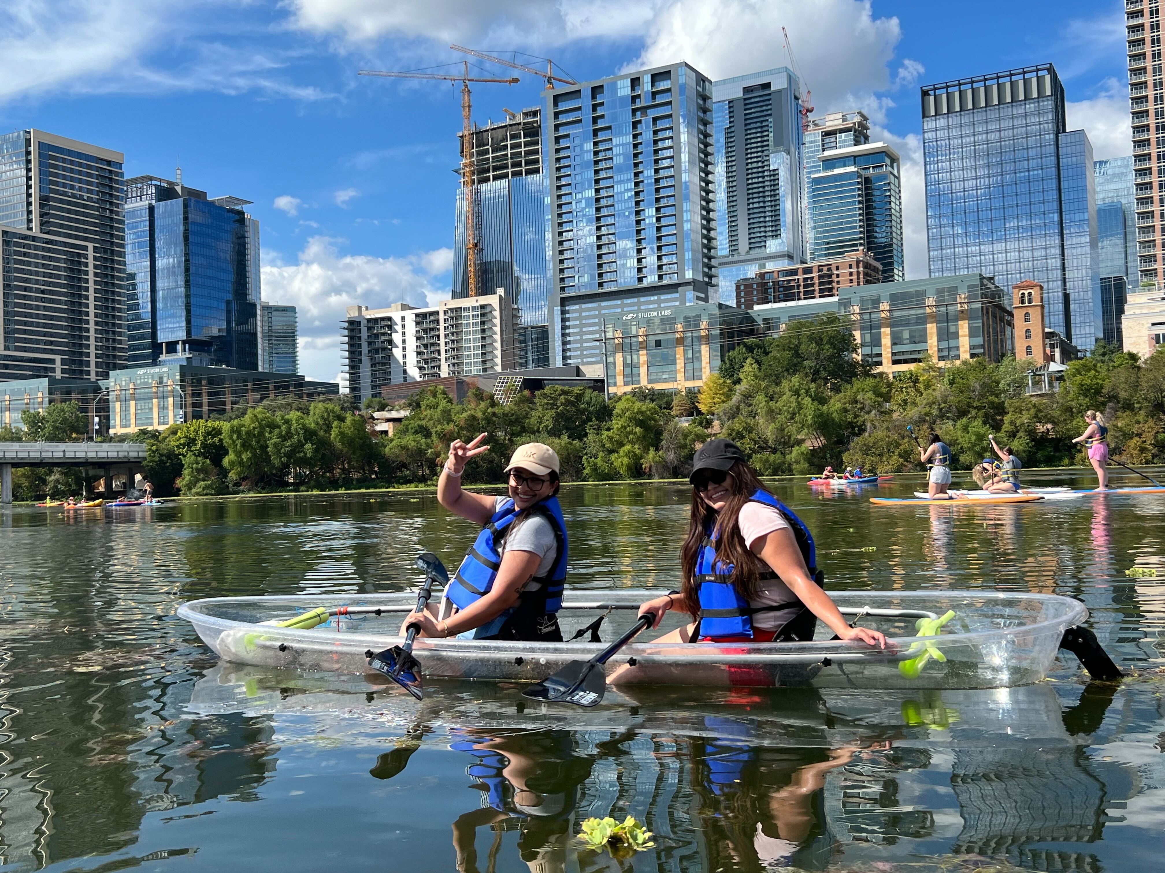 a group of people riding on the back of a boat in the water