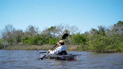 a man rowing a boat in a body of water