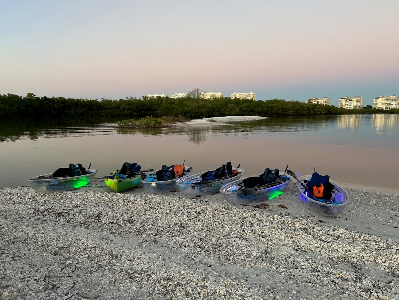 a group of people on a beach near a body of water