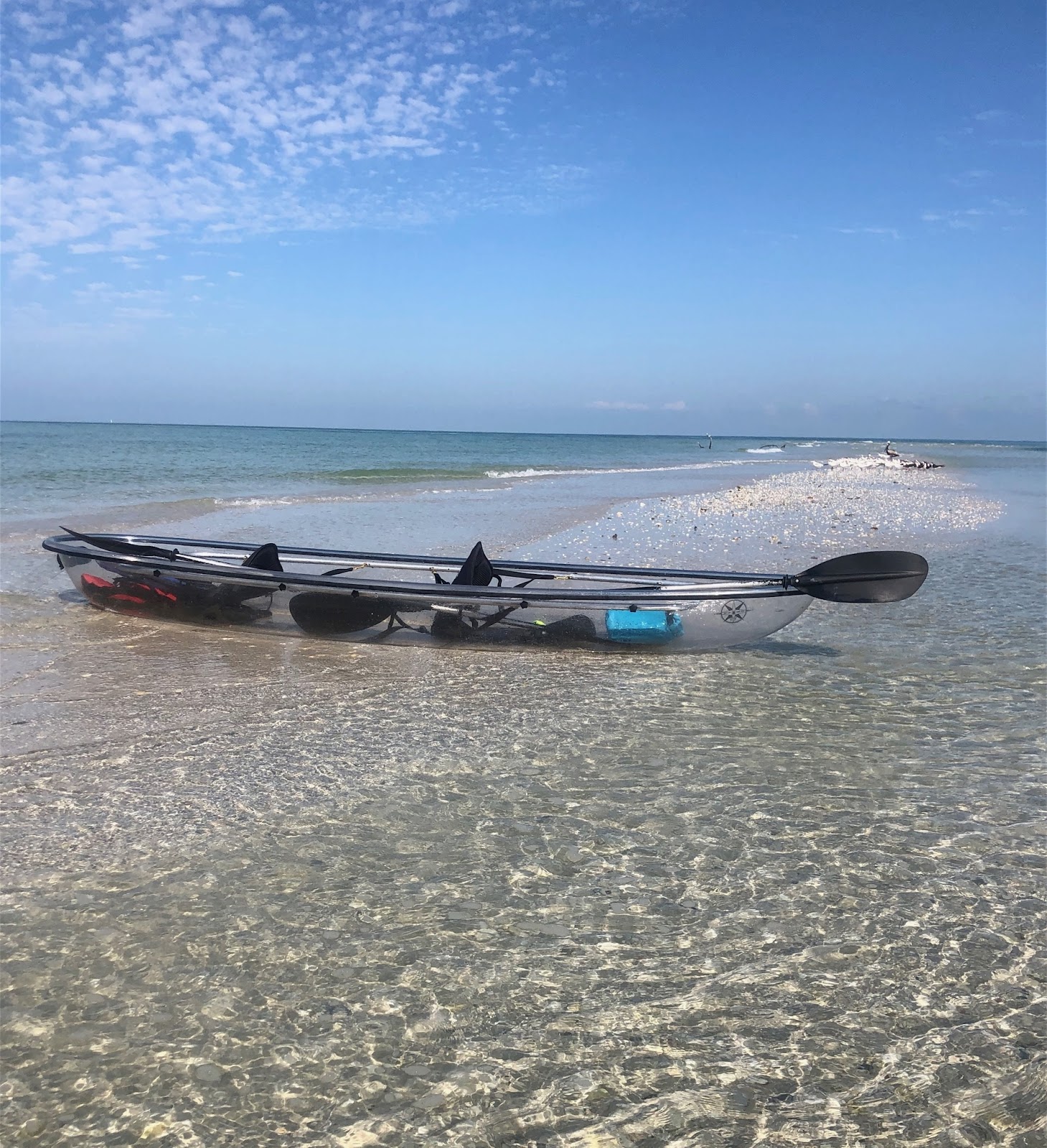 unnamed_fbe47d a boat sitting on top of a sandy beach next to the ocean