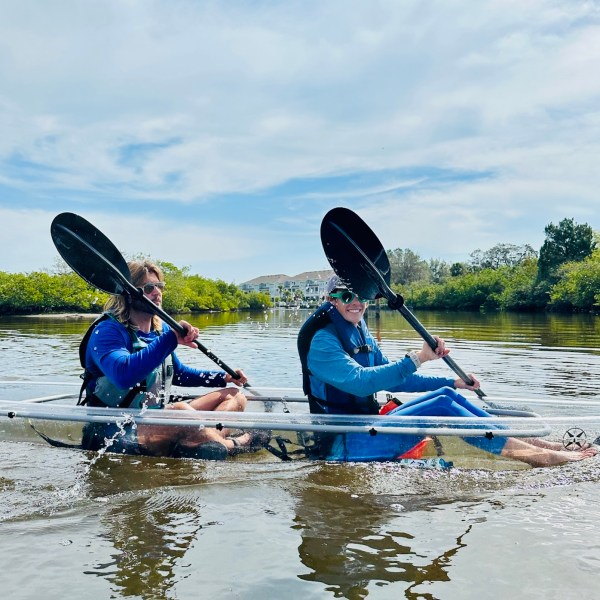 a group of people rowing a boat in a body of water