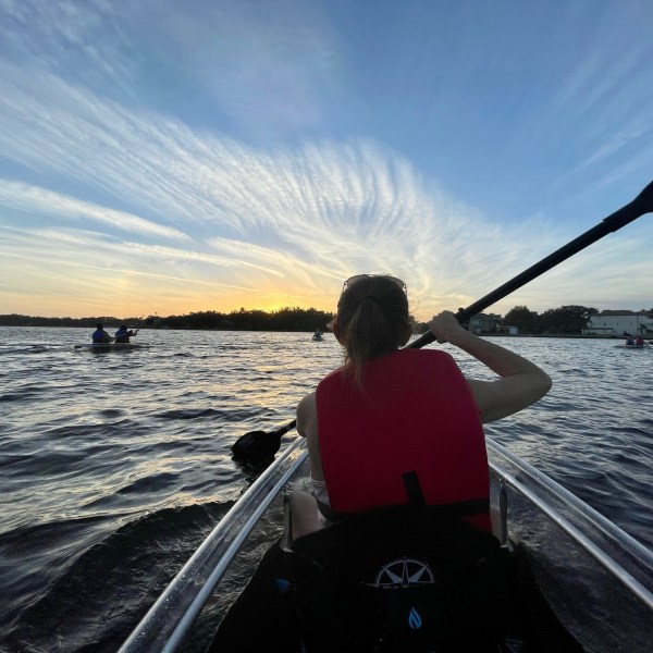 a man standing next to a body of water