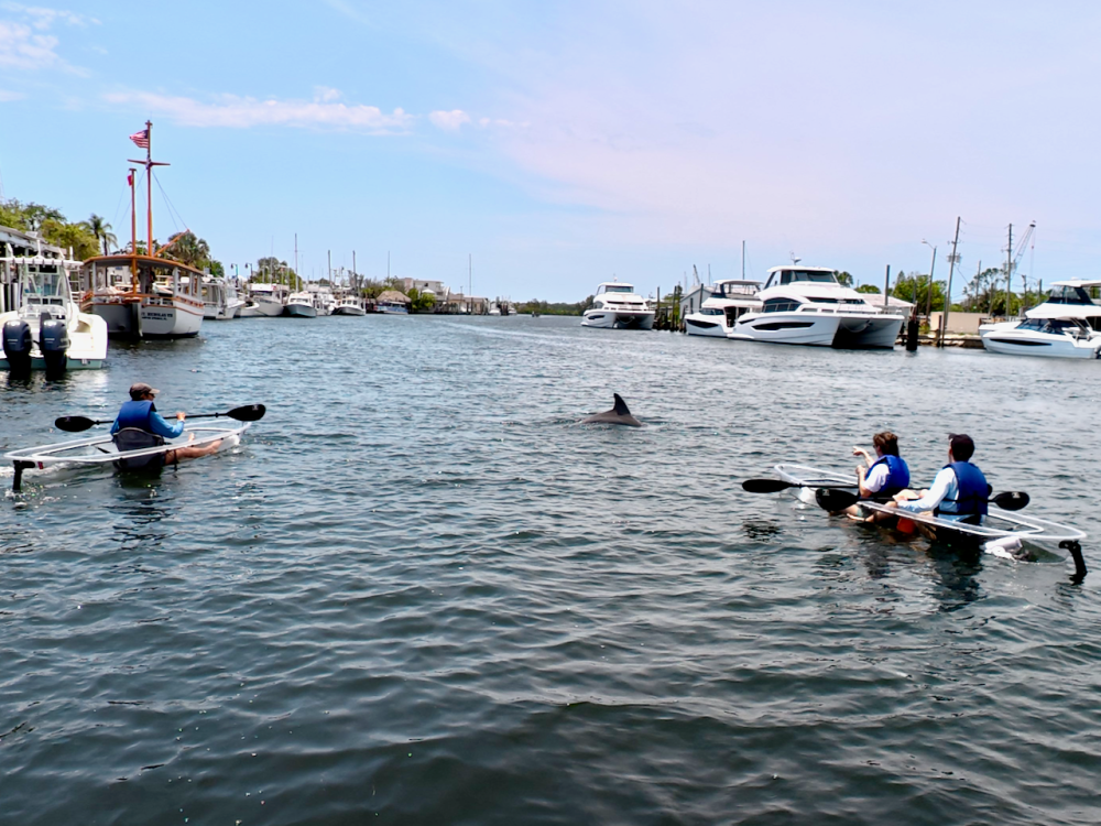 a group of people in a small boat in a body of water