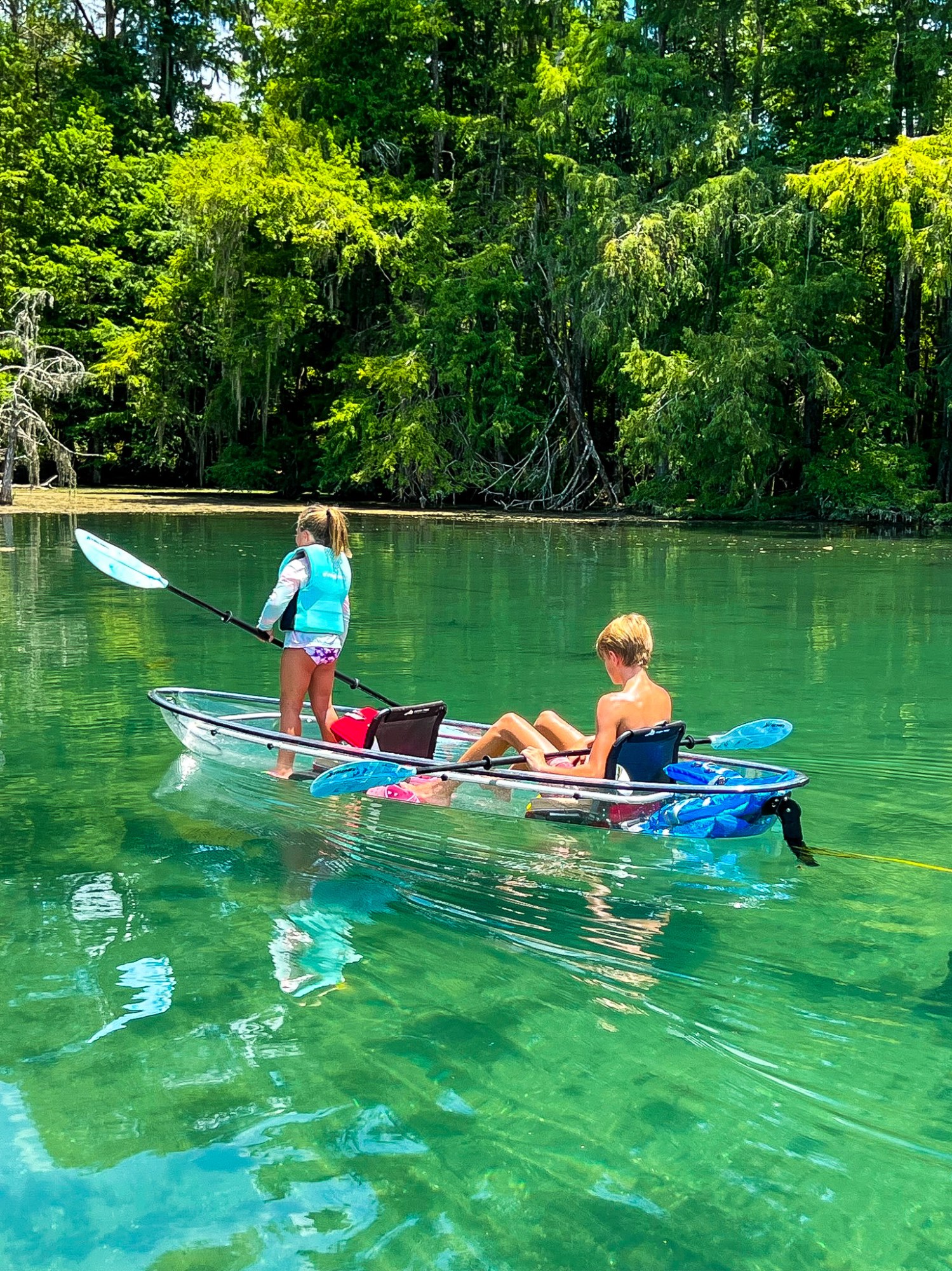 a group of people rowing a boat in the water