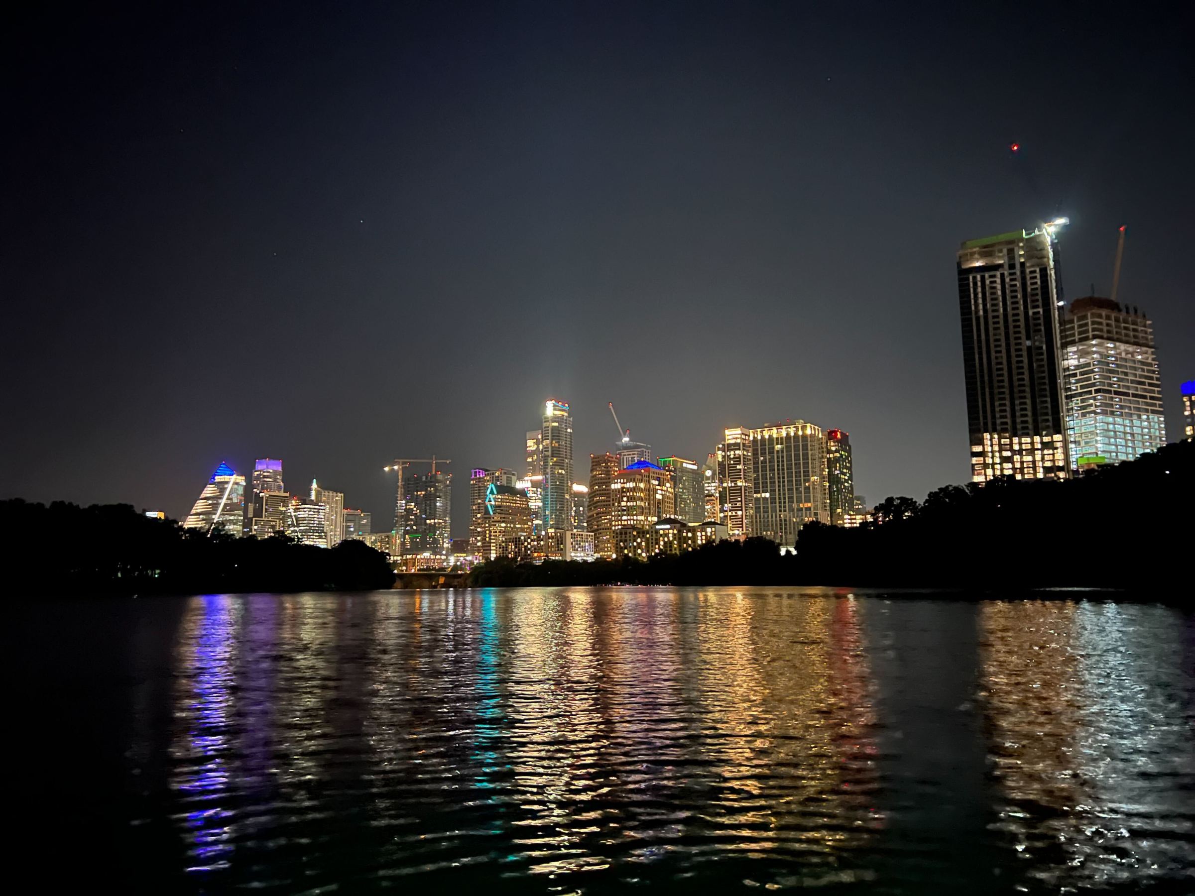 a body of water with a city in the background