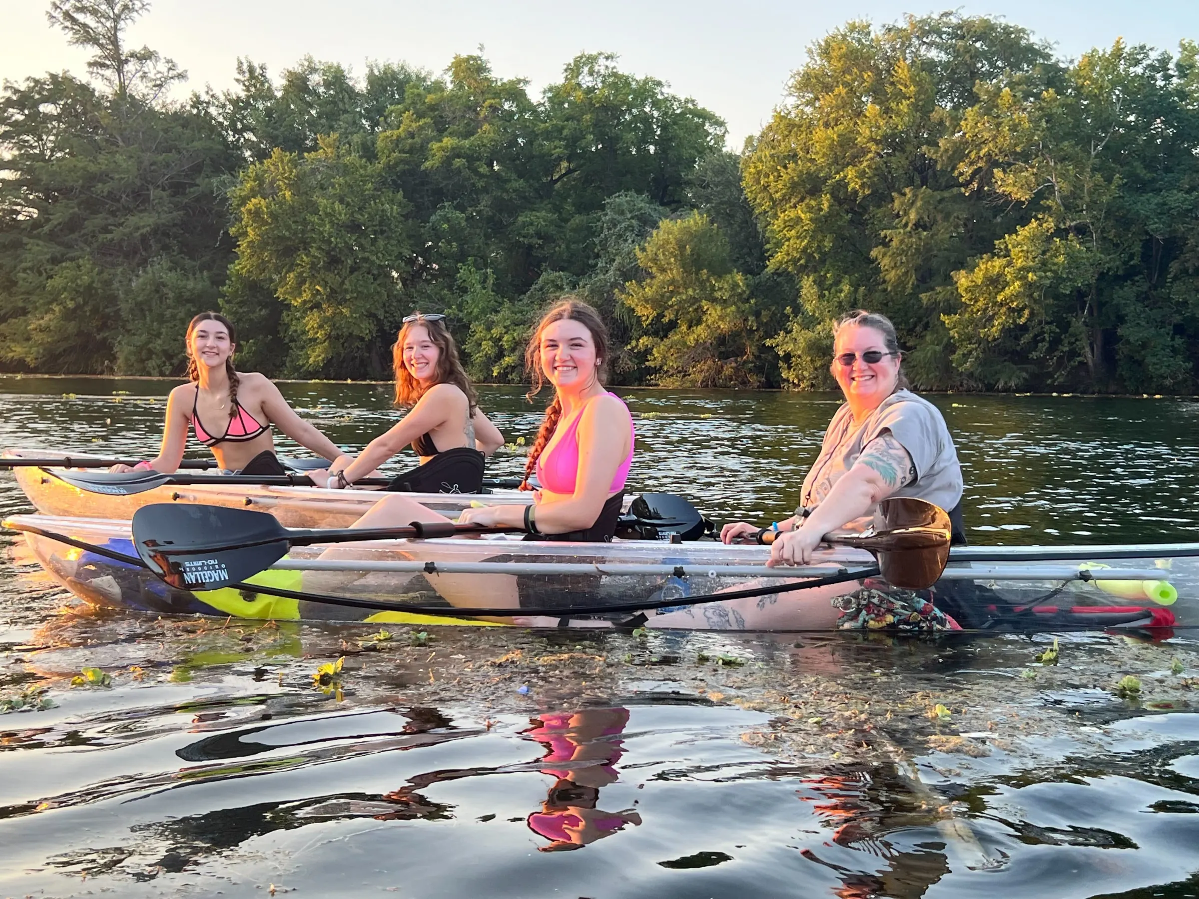a group of people rowing a boat in the water