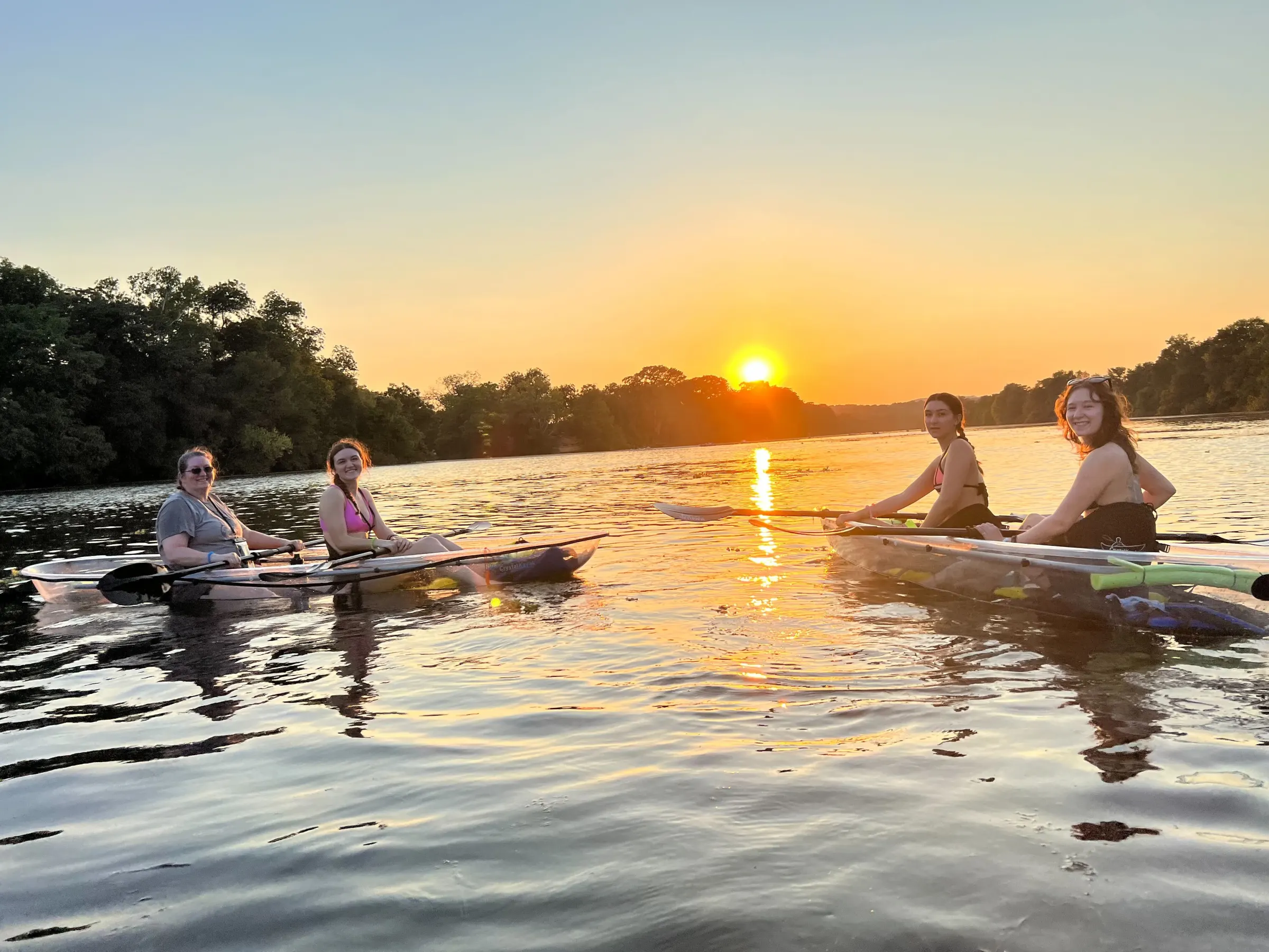 a group of people riding on the back of a boat in the water