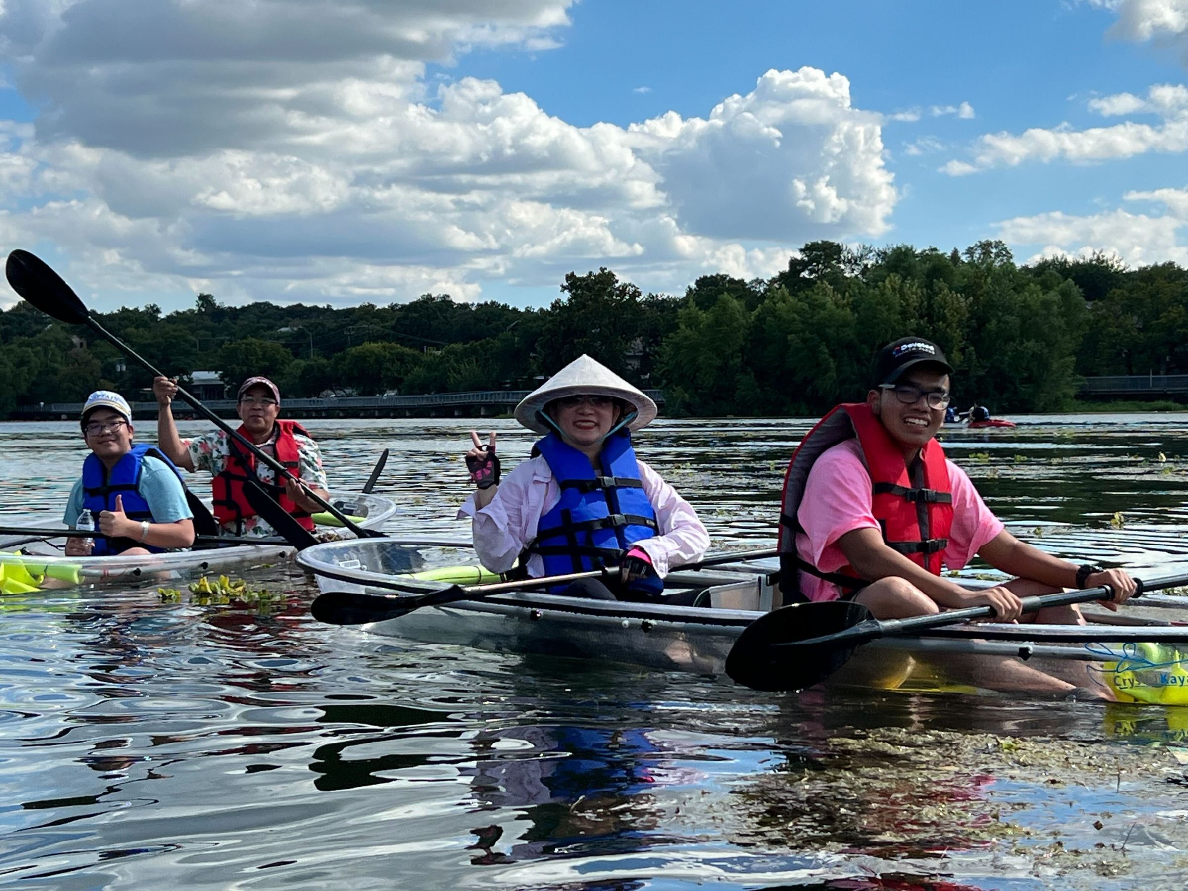 a group of people rowing a boat in the water