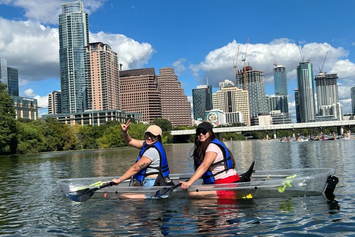a group of people rowing a boat in the water