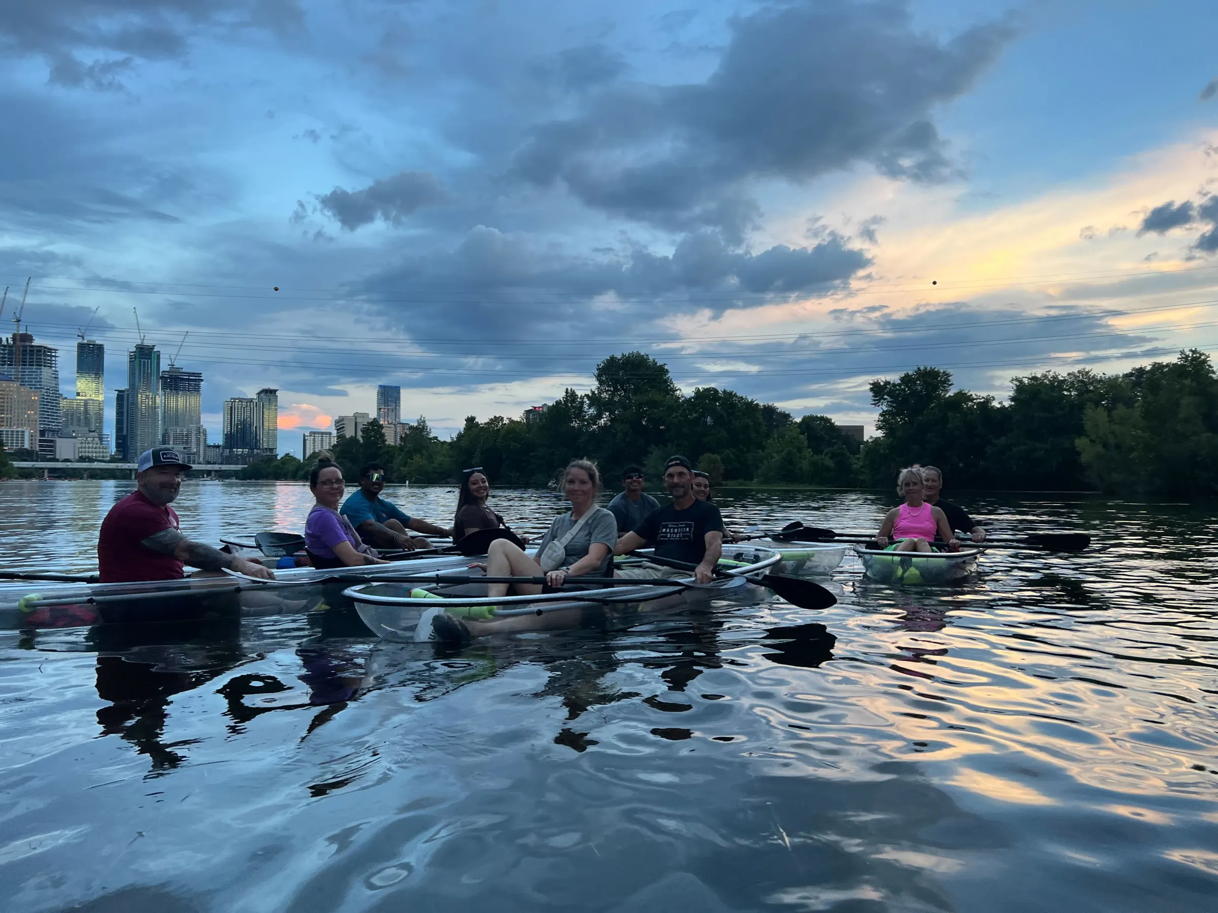 a group of people riding on the back of a boat in the water