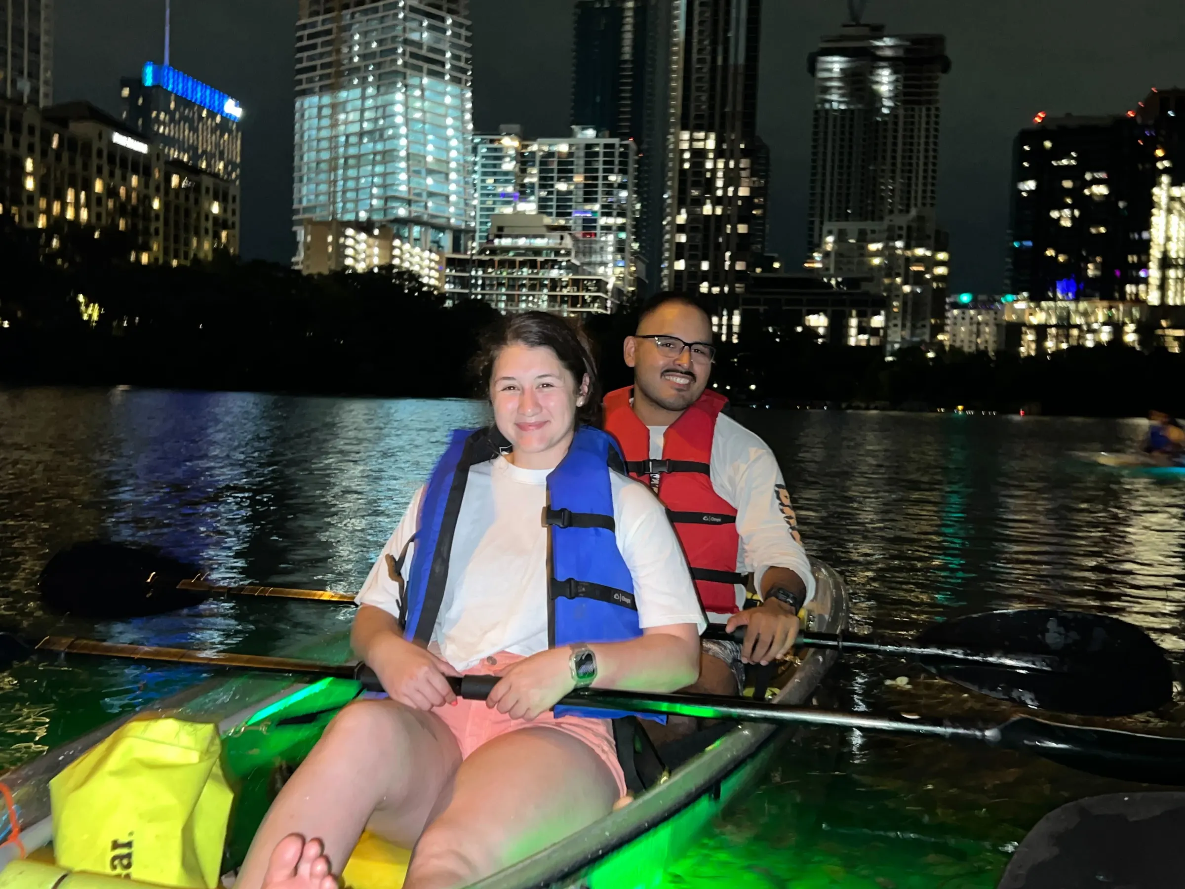 a person in a green boat on a body of water