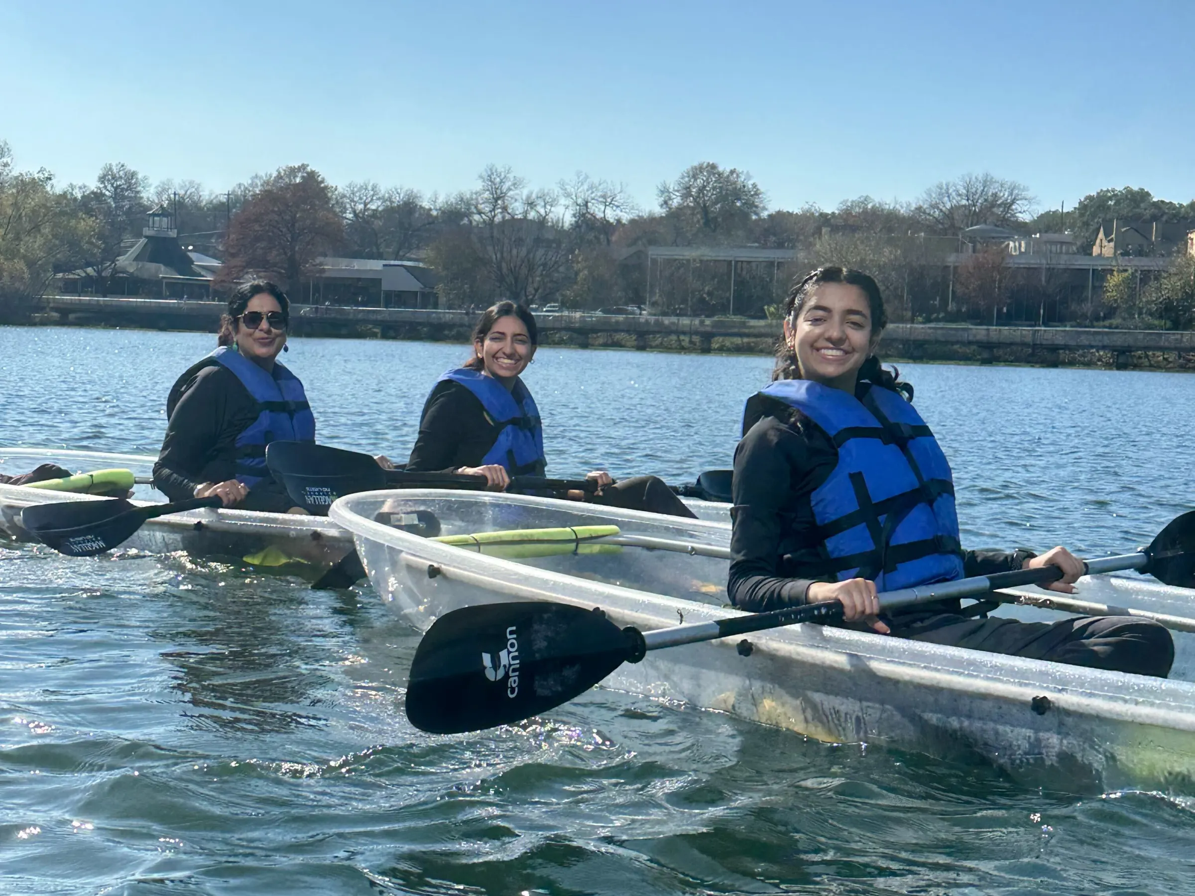 a group of people rowing a boat in the water