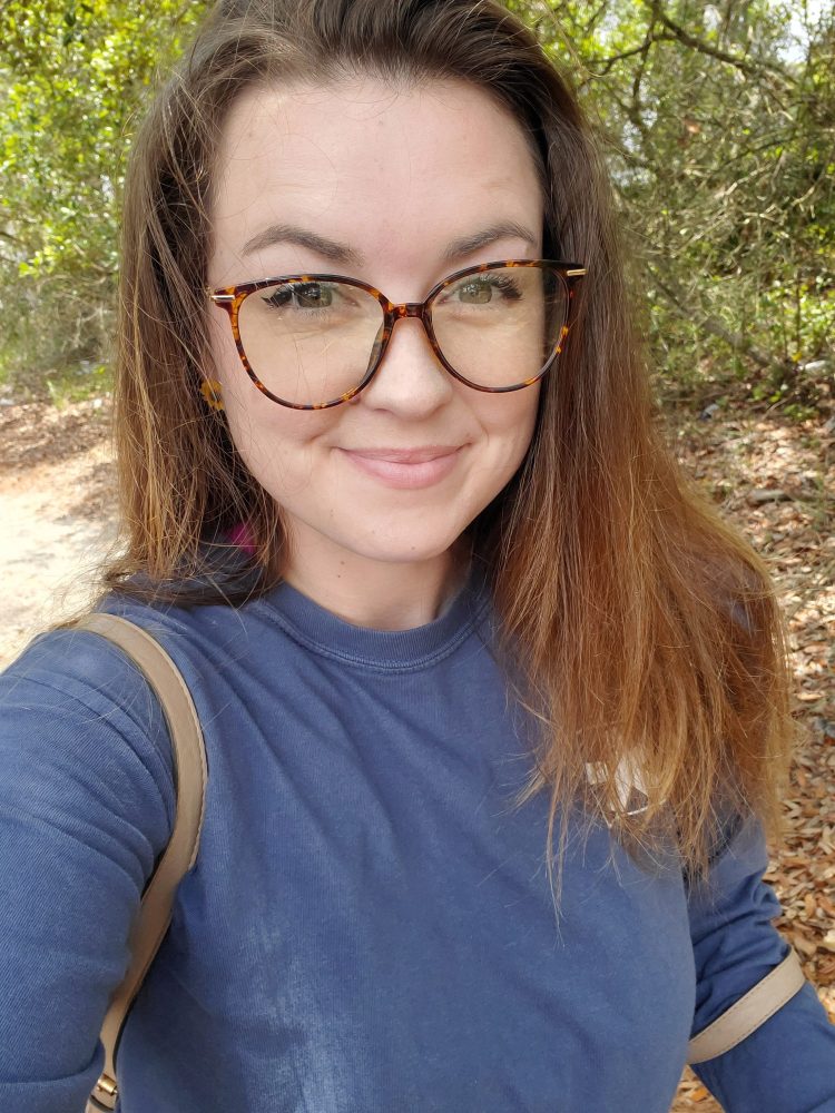 a close up of a person in glasses looking at the camera