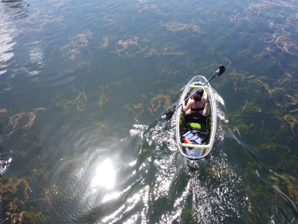 a man flying through the air on a mountain lake