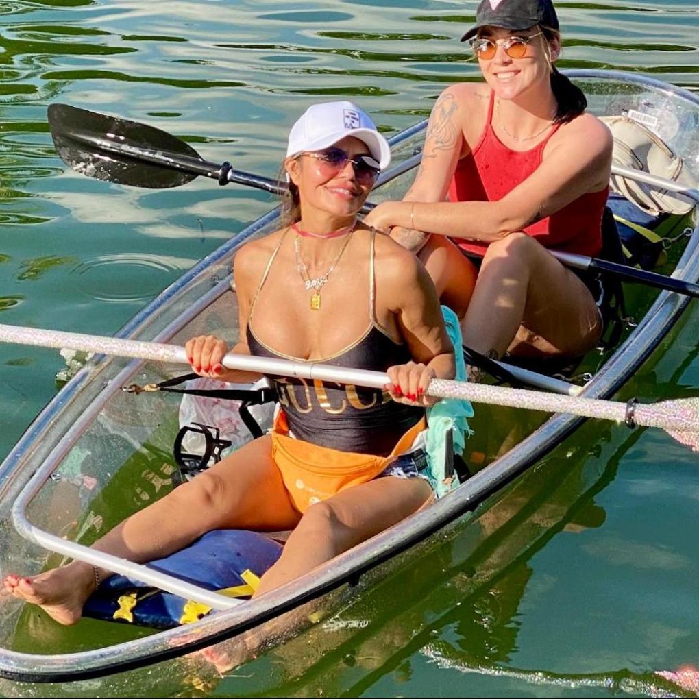 a woman sitting on a boat in the water