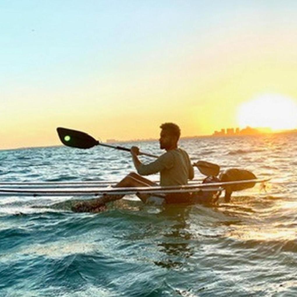 a man standing next to a body of water