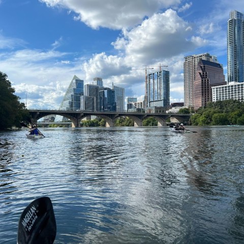 a large body of water with a city in the background