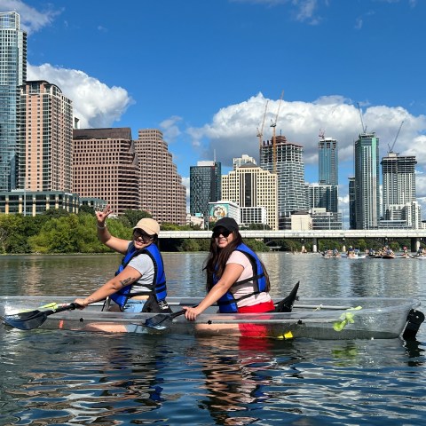 a group of people riding on the back of a boat in the water