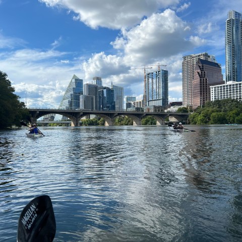 a large body of water with a city in the background