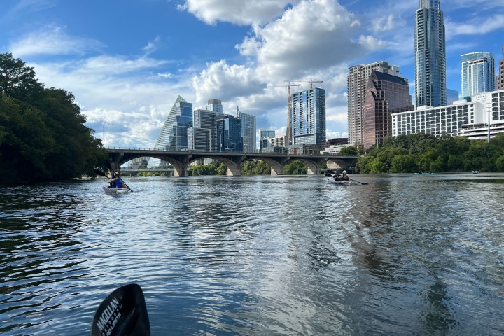 a large body of water with a city in the background