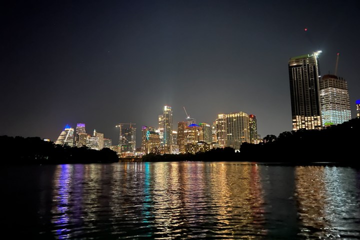 a large body of water with a city in the background