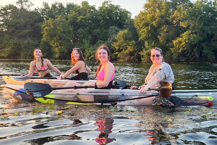 a group of people rowing a boat in the water