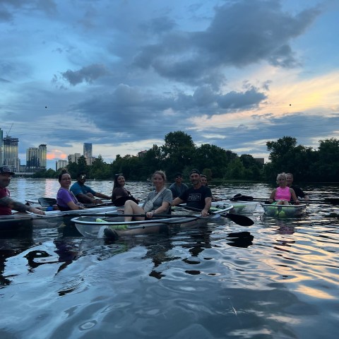 a group of people rowing a boat in the water