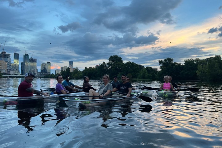 a group of people rowing a boat in the water