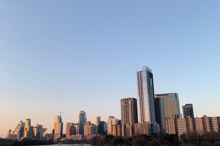 a bridge over a body of water with a city in the background