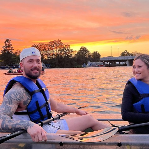 a person sitting in a boat on a body of water