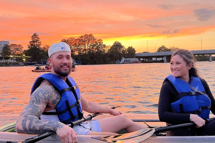 a person sitting in a boat on a body of water