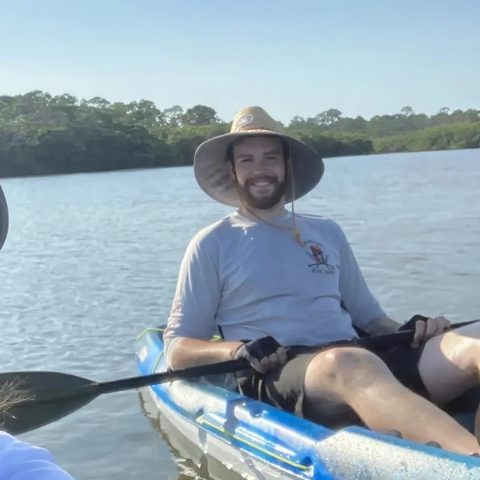 a group of people in a boat on a body of water