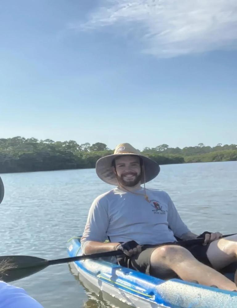 a person sitting in a boat on a body of water