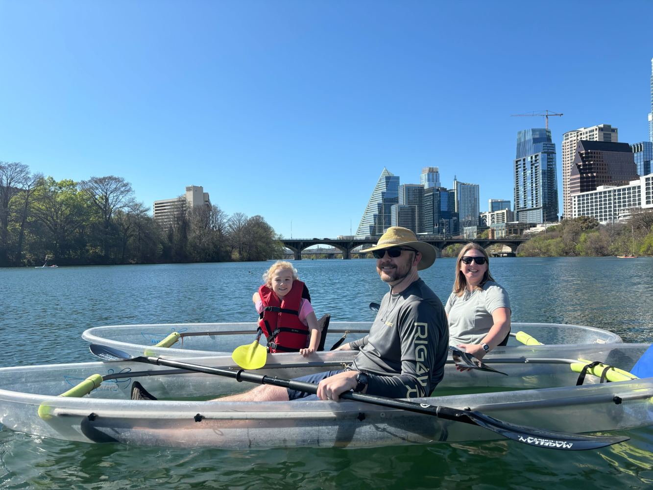 a group of people rowing a boat in the water