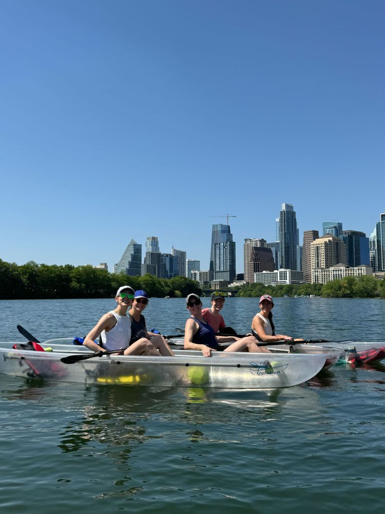 a group of people rowing a boat in the water