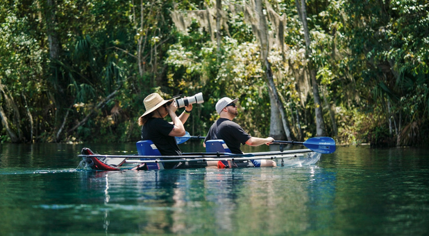 a group of people rowing a boat in the water