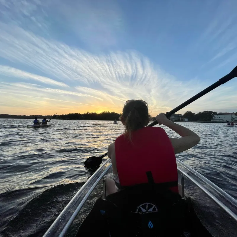 a man standing next to a body of water