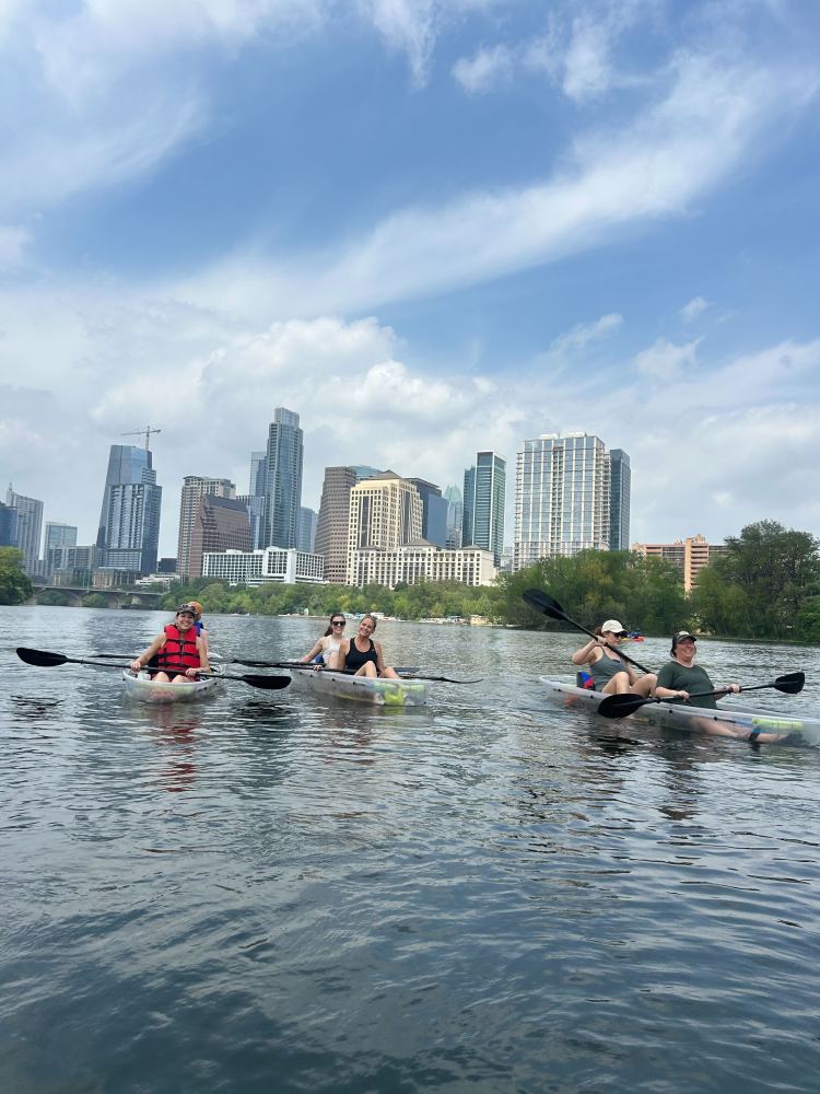 a group of people rowing a boat in the water