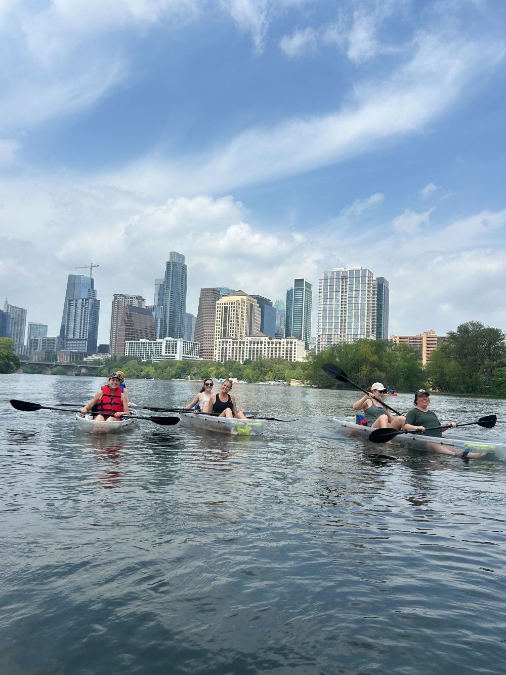 a group of people rowing a boat in the water