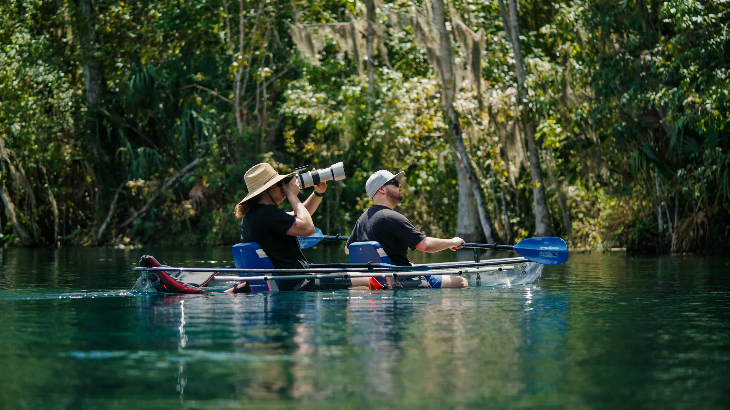 a man riding on the back of a boat in the water