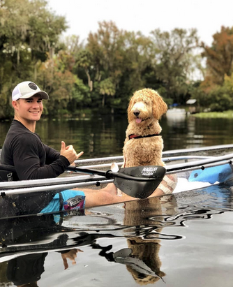 a group of people rowing a boat in the water