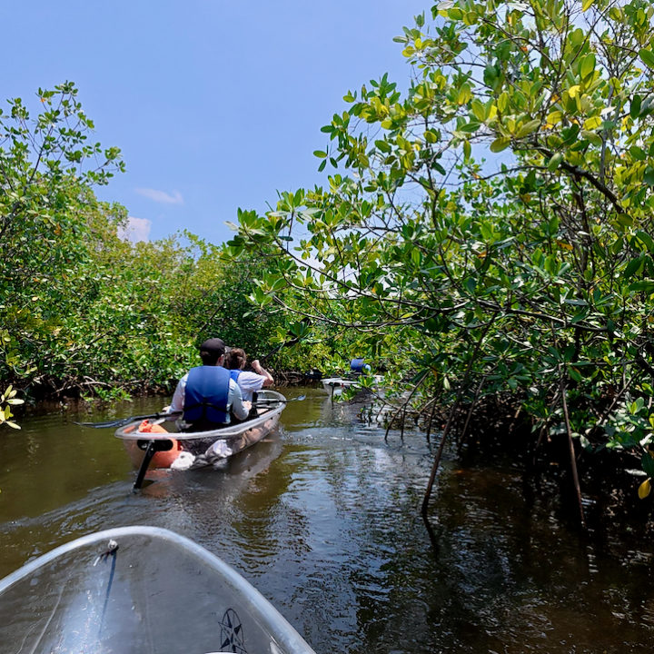 a man riding a motorcycle down a river