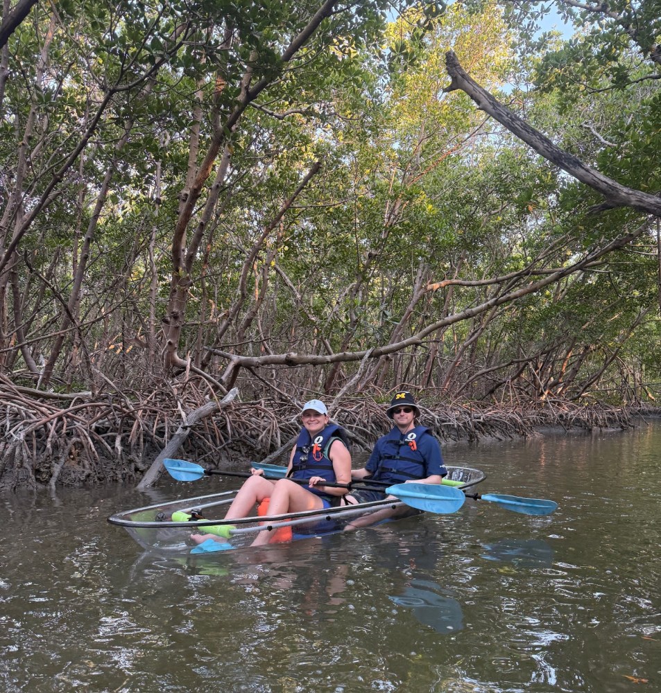 a group of people rowing a boat in the water