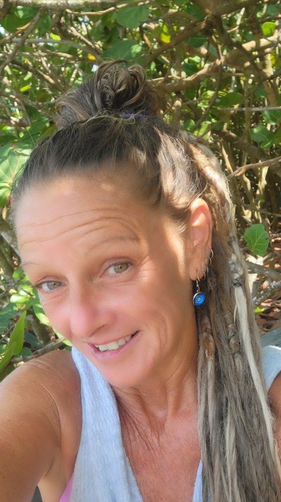 a woman standing next to a body of water