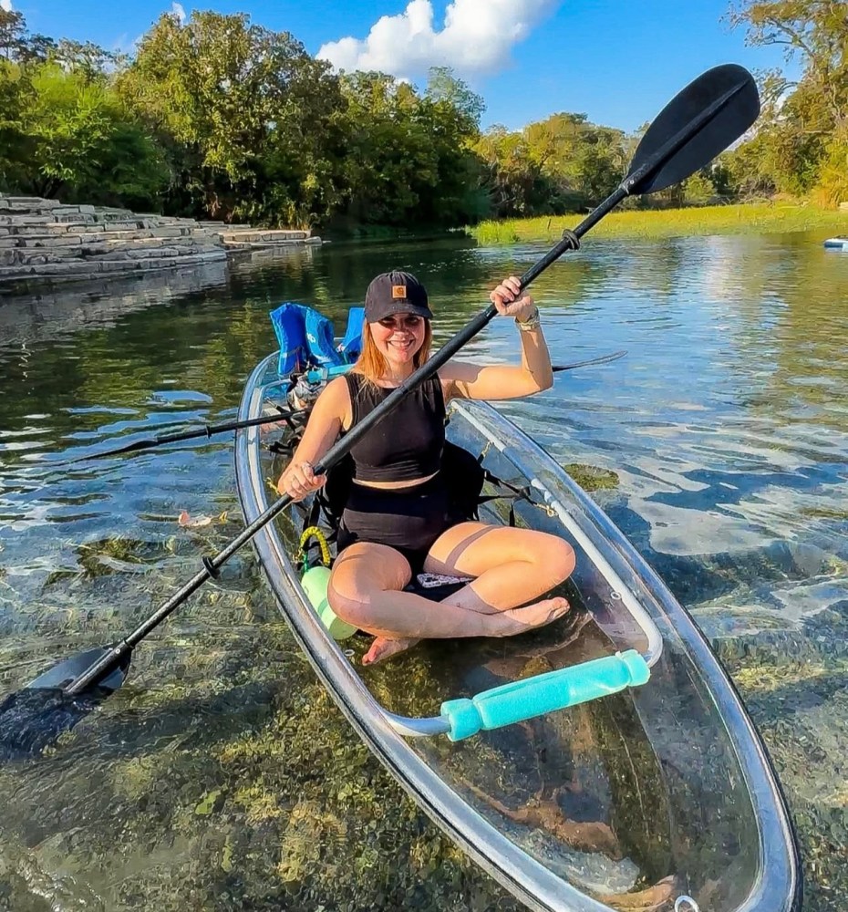 a person riding on the back of a boat in the water