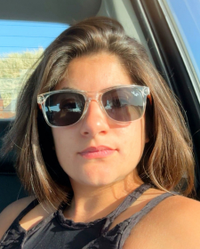 a woman wearing sunglasses taking a selfie