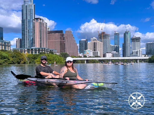a group of people rowing a boat in the water