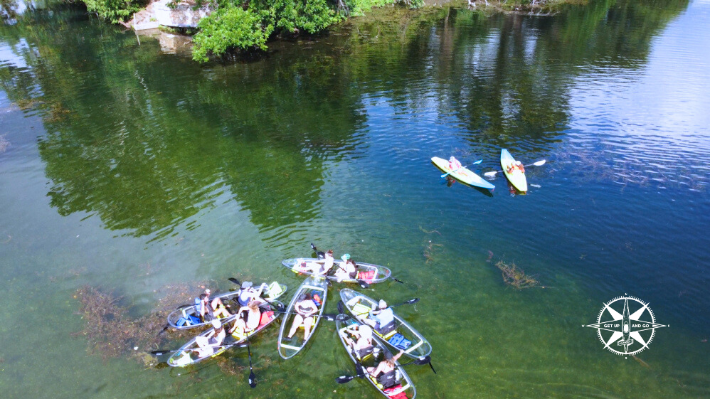 a group of people standing next to a body of water